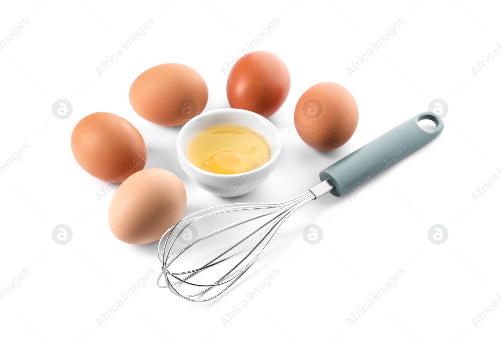 Photo of Whisk, whole and broken eggs isolated on white