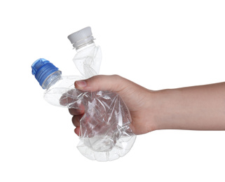 Woman holding crumpled bottles on white background, closeup. Plastic recycling