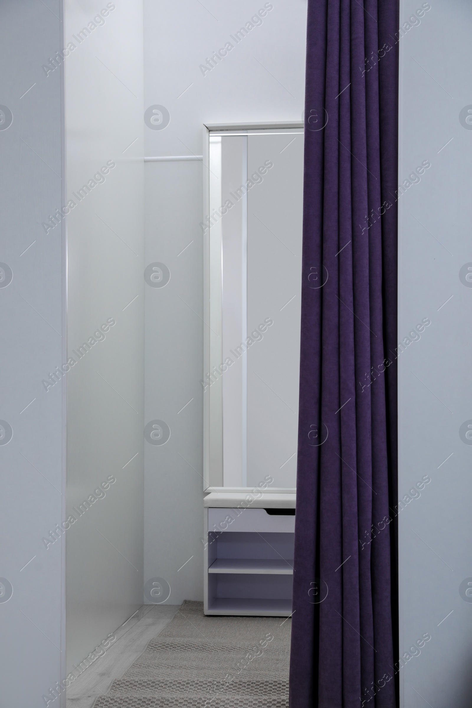 Photo of Empty dressing room in fashion store. Stylish interior