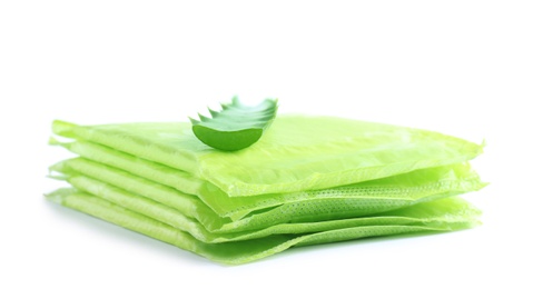 Photo of Stack of menstrual pads and aloe leaf on white background. Gynecological care