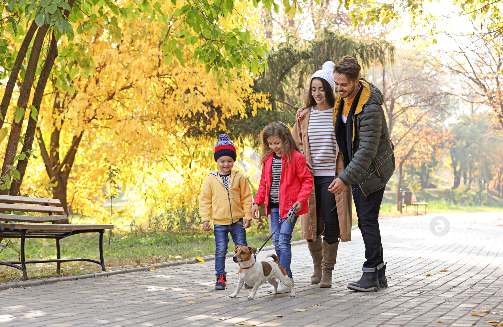 Photo of Happy family with children and dog in park. Autumn walk