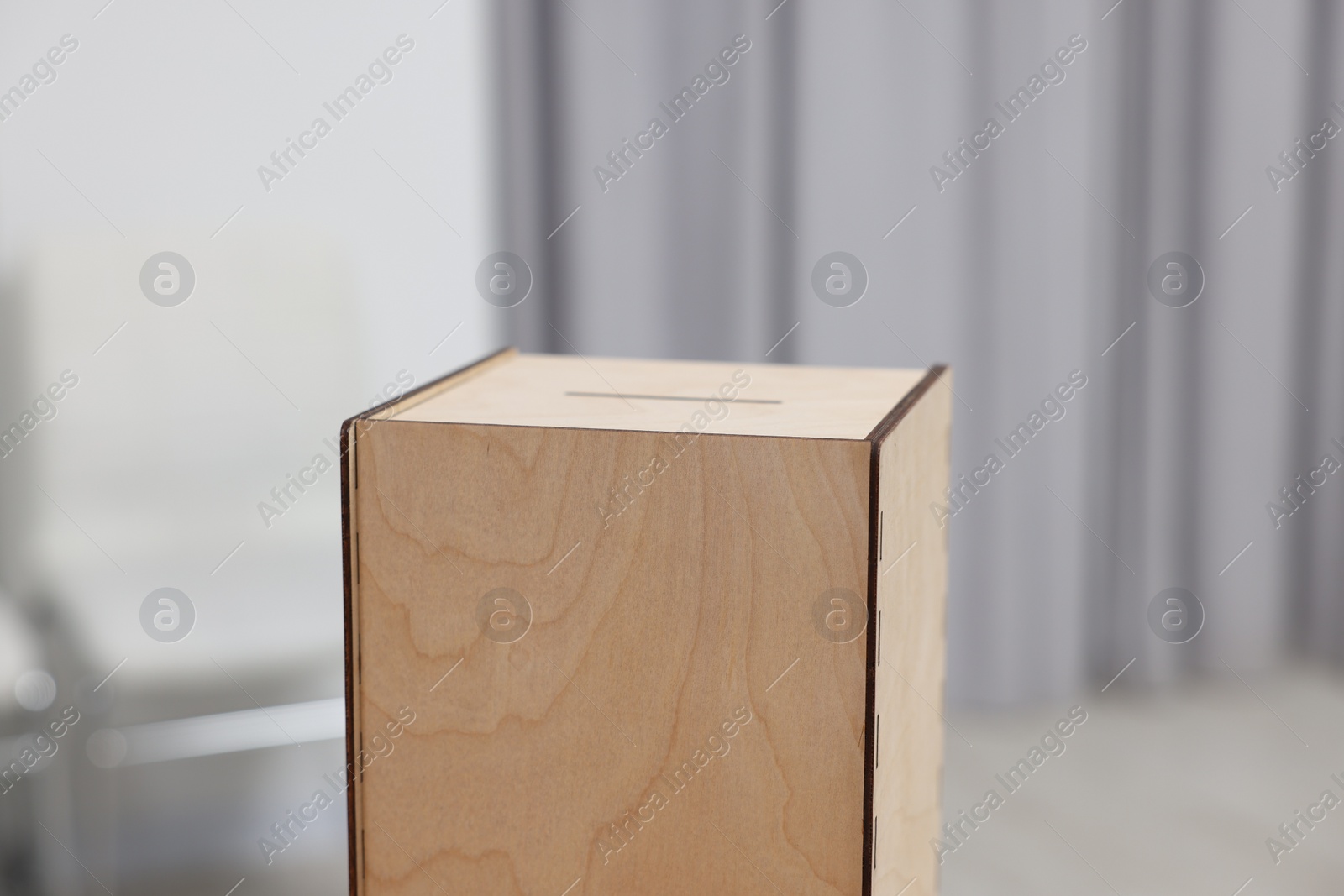 Photo of Wooden ballot box on blurred background, closeup