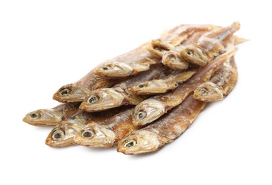 Photo of Delicious dried salted anchovies on white background