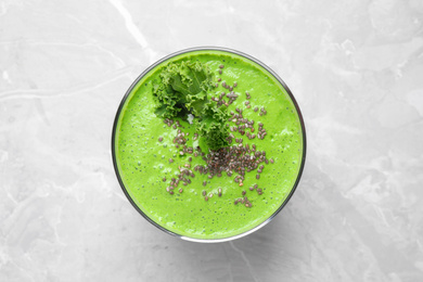 Photo of Tasty kale smoothie with chia seeds on light grey marble table, top view