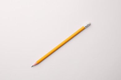 Sharp graphite pencil with eraser on white background, top view