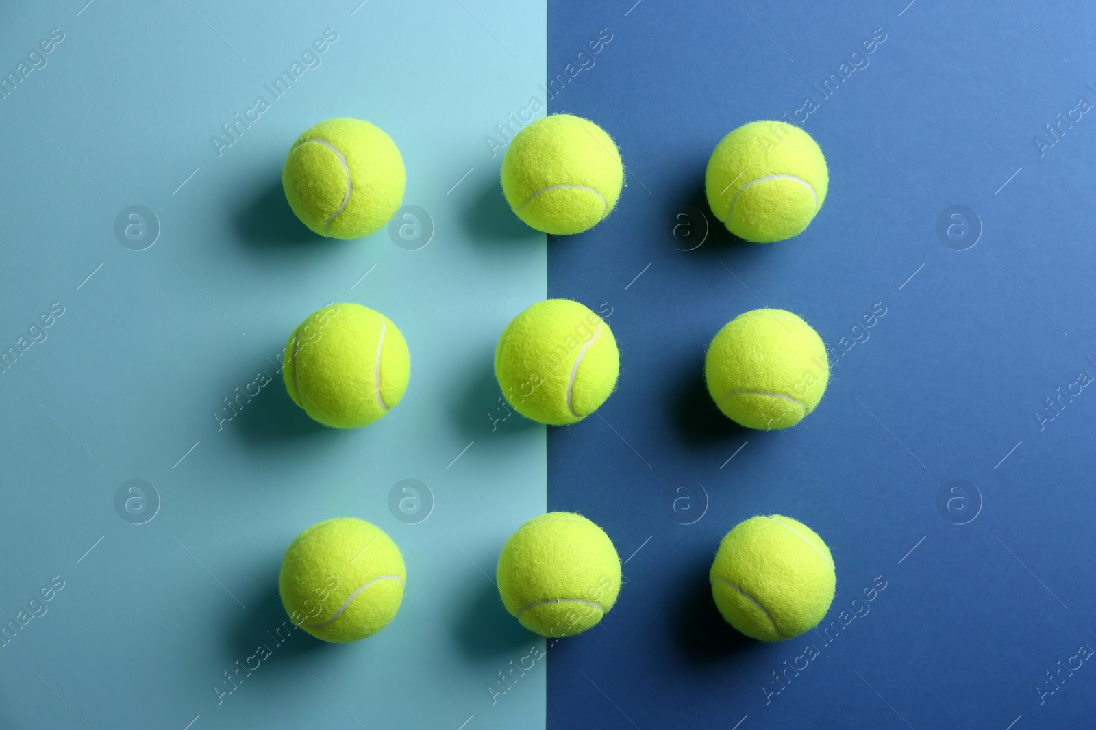 Photo of Tennis balls on color background, flat lay. Sports equipment