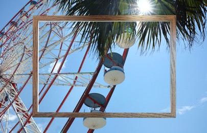 Image of Wooden frame and observation wheel under on sunny day