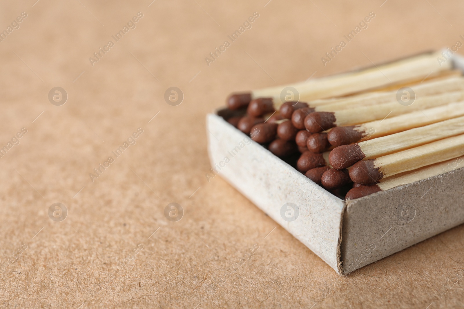 Photo of Open box with matches on craft paper, space for text