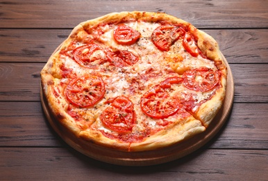 Photo of Hot cheese pizza Margherita on wooden table