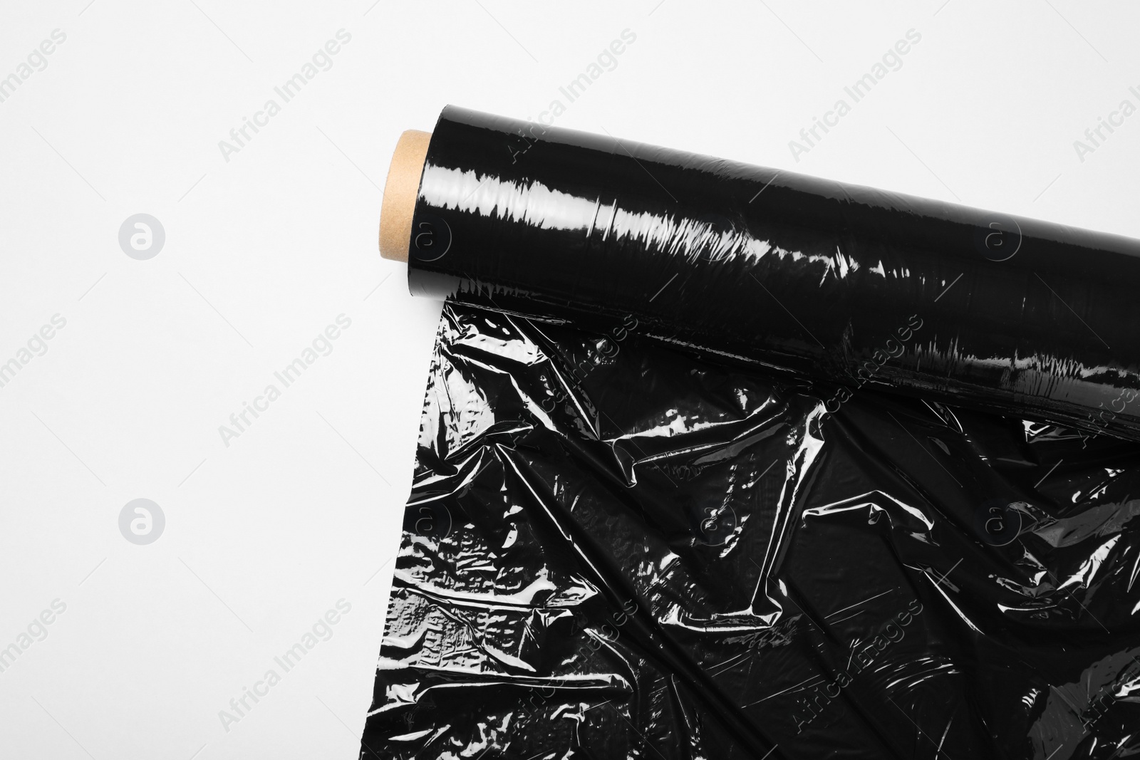 Photo of Roll of plastic stretch wrap film on white background, top view