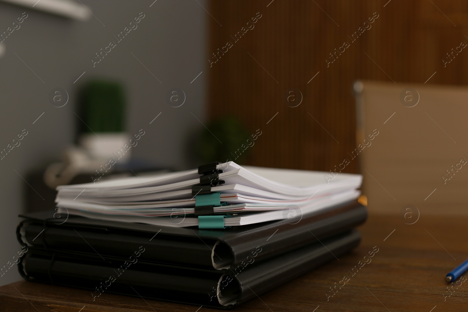 Photo of Stack of documents on wooden table in office. Space for text