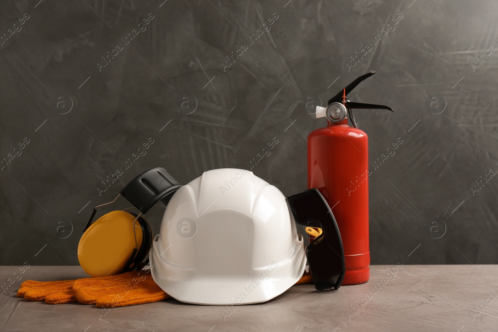Photo of Composition with safety equipment on table against grey background