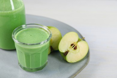 Photo of Tasty fresh apple smoothie on white table, space for text
