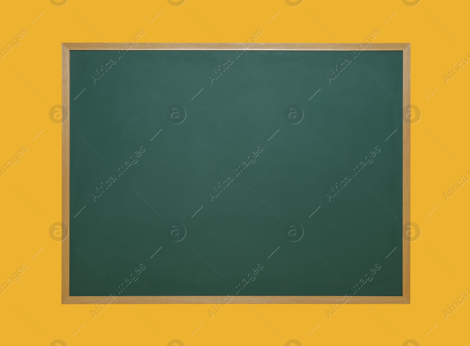 Photo of Clean green chalkboard on orange background. School equipment
