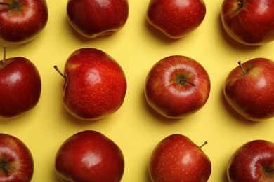 Photo of Flat lay composition with ripe juicy red apples on yellow background