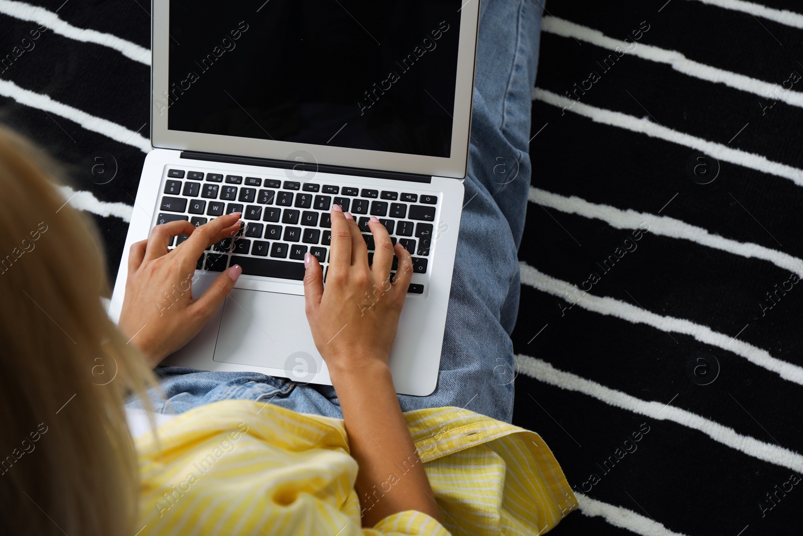 Photo of Woman working with laptop at home, closeup view