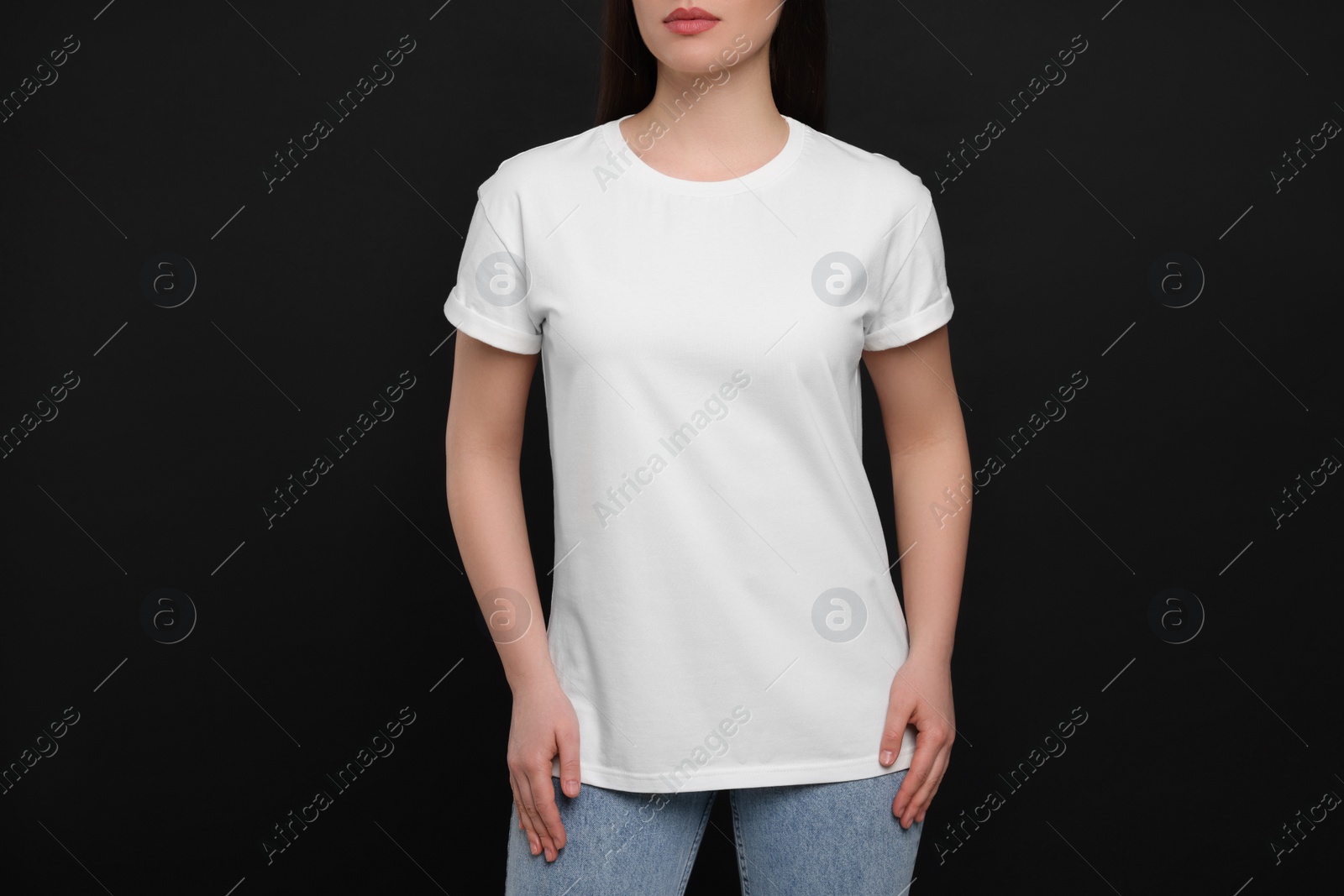 Photo of Woman wearing white t-shirt on black background, closeup