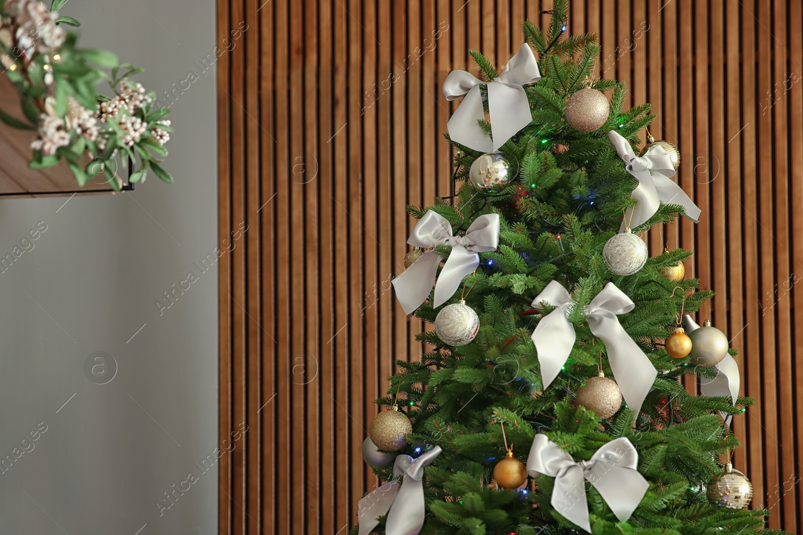 Photo of Beautiful Christmas tree with stylish decor indoors