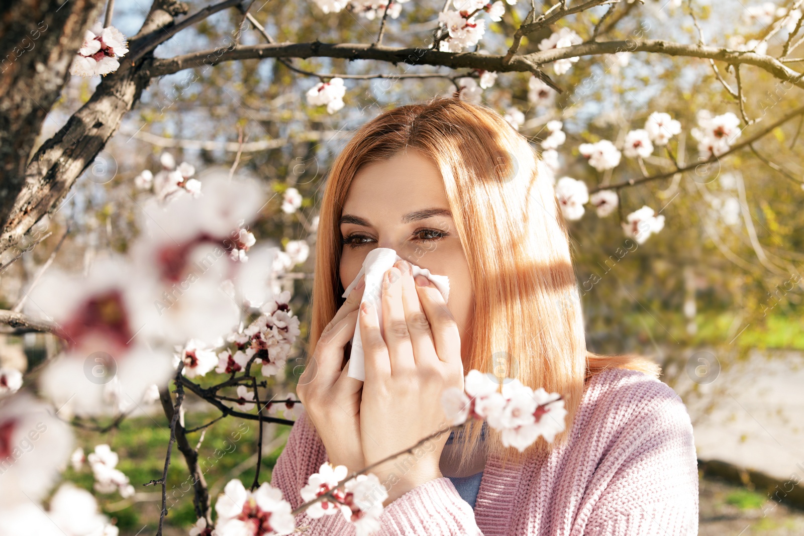 Photo of Woman suffering from seasonal allergy outdoors on sunny day