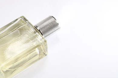 Photo of Luxury men`s perfume in bottle on white background, space for text