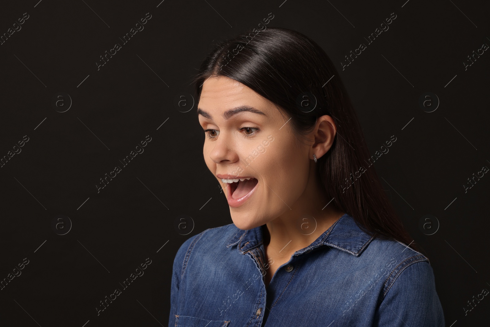 Photo of Personality concept. Emotional woman on black background