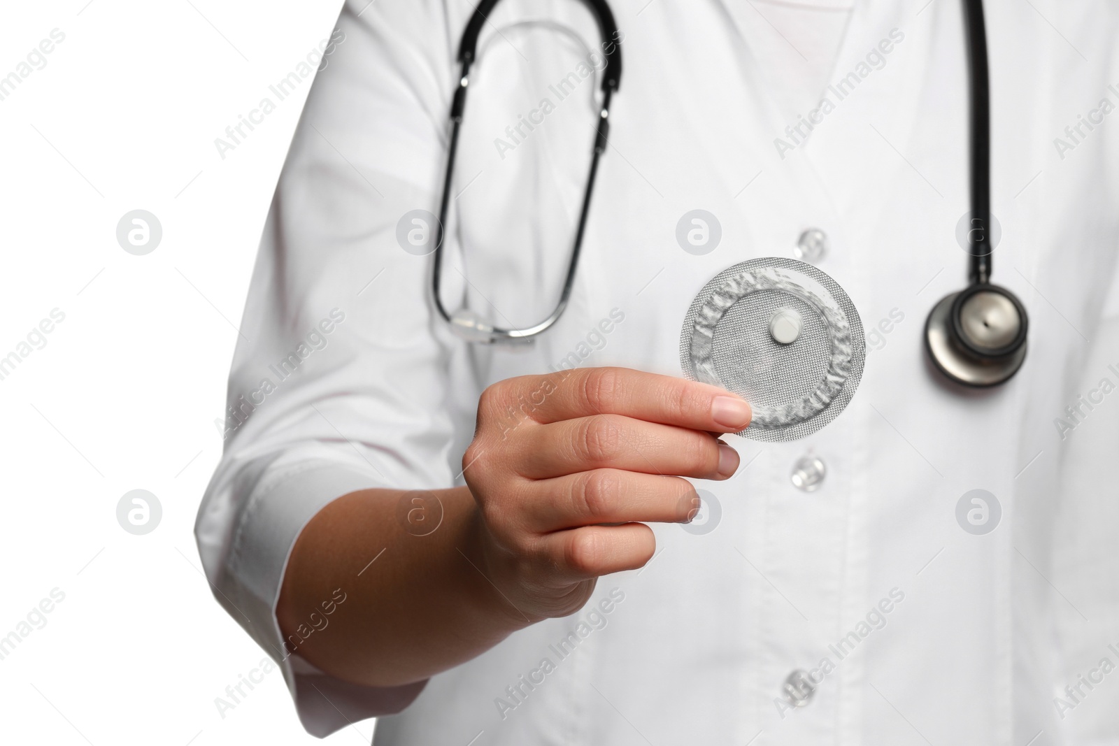 Photo of Doctor holding blister of emergency contraception pill against white background, focus on hand