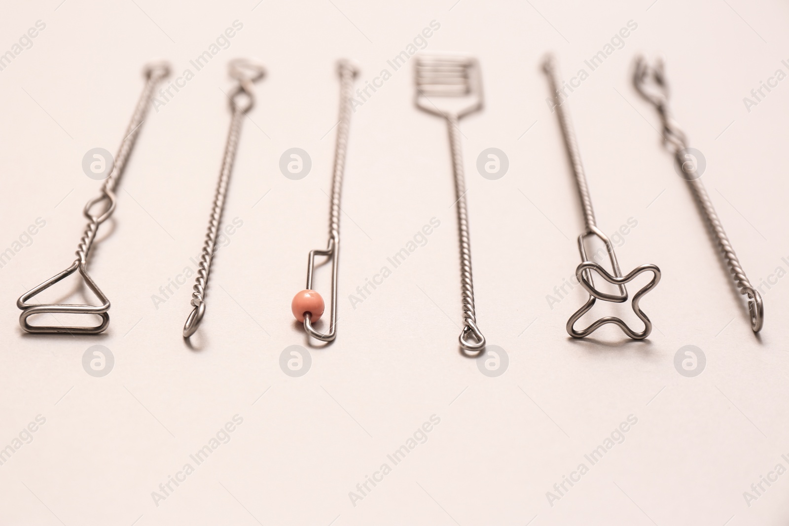 Photo of Set of logopedic probes for speech therapy on beige background