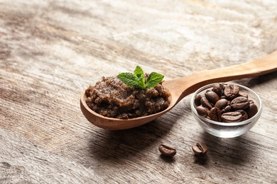 Photo of Handmade natural body scrub and coffee beans on wooden background