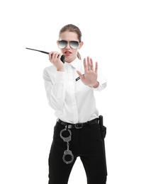 Female security guard using portable radio transmitter on white background