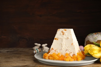 Traditional cottage cheese Easter paskha with dried apricot on wooden table, space for text