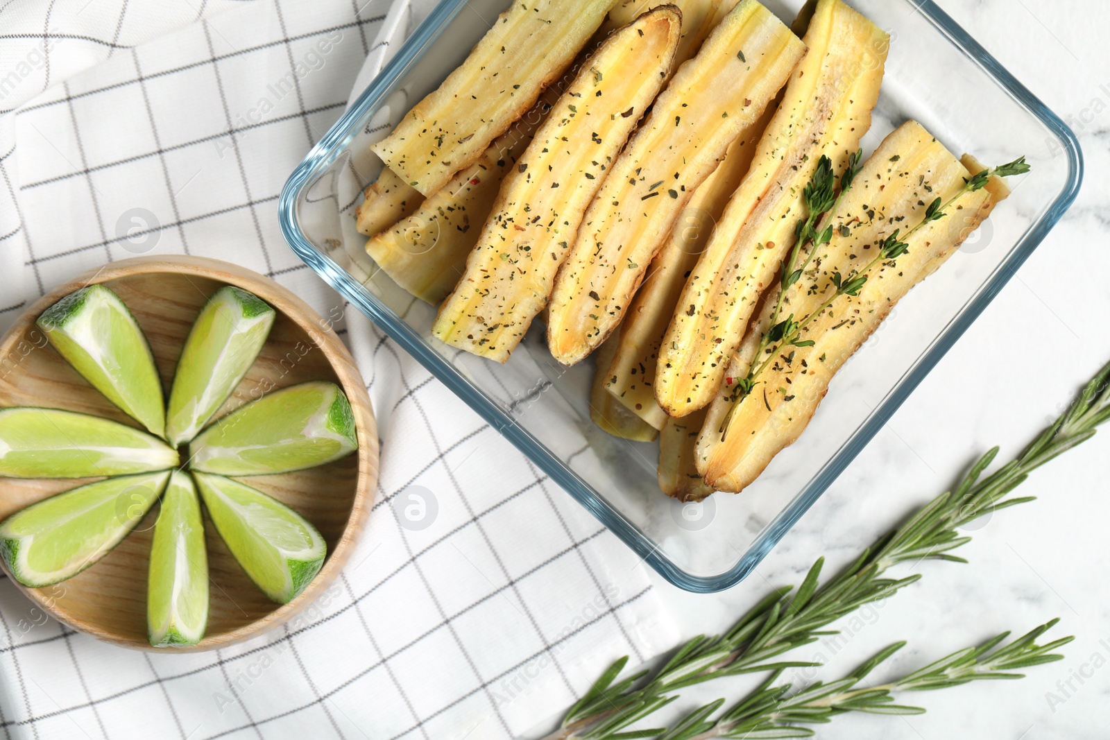 Photo of Flat lay composition with raw cut white carrot in  baking dish on white marble table