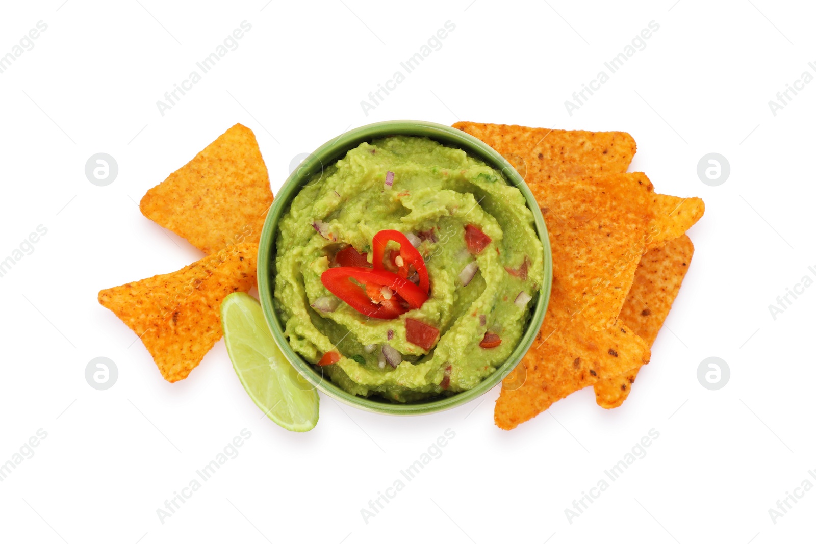 Photo of Bowl of delicious guacamole, lime and nachos chips isolated on white, top view