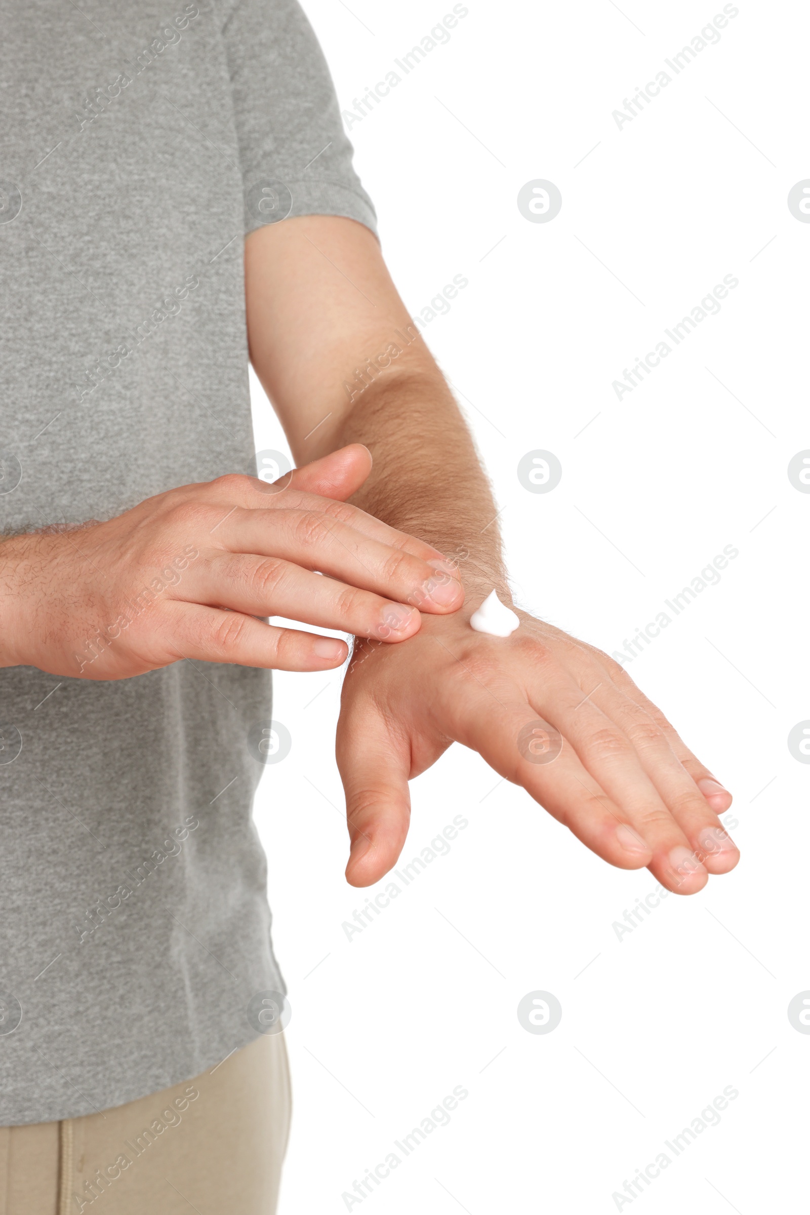 Photo of Man applying cream onto hand against white background, closeup