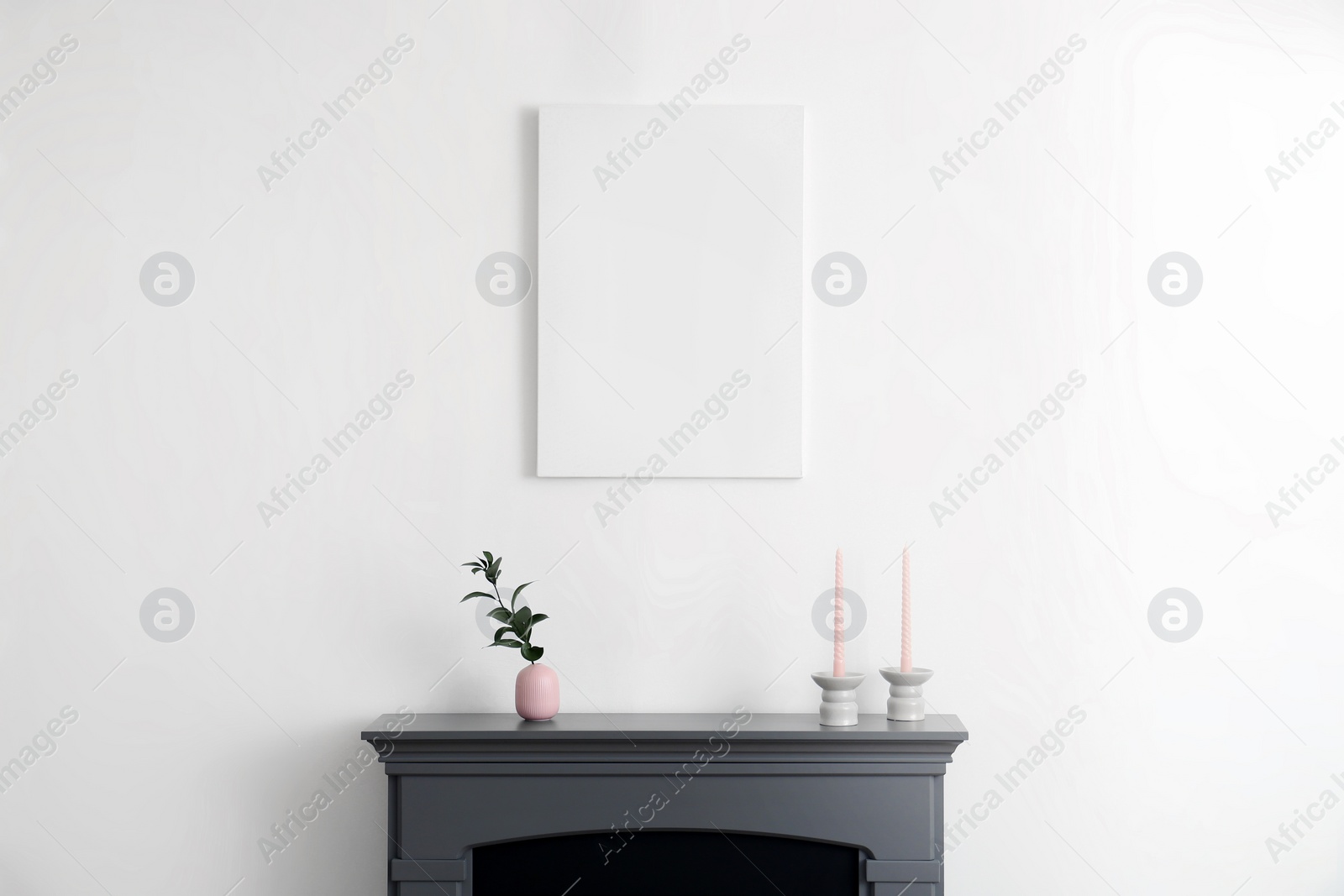 Photo of Fireplace, decorative elements and poster in room. Interior design