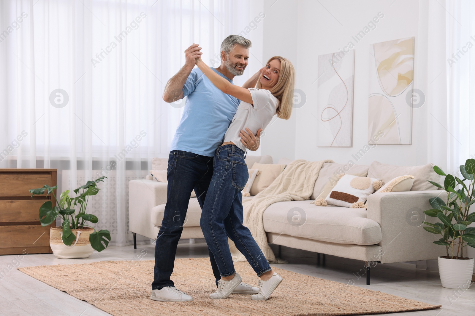 Photo of Happy affectionate couple dancing at home, space for text. Romantic date