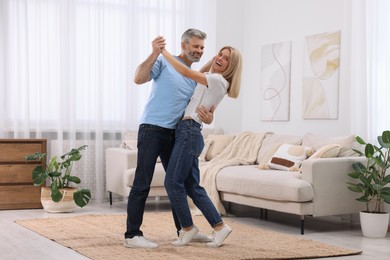 Photo of Happy affectionate couple dancing at home, space for text. Romantic date