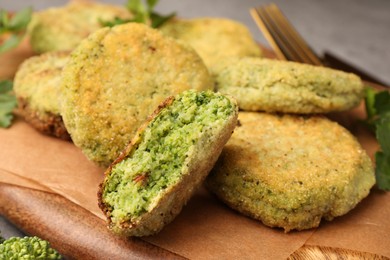 Photo of Delicious cutlets with broccoli and parsley on wooden board, closeup. Vegan dish