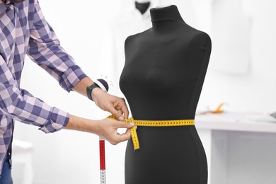 Tailor measuring mannequin in workshop, closeup
