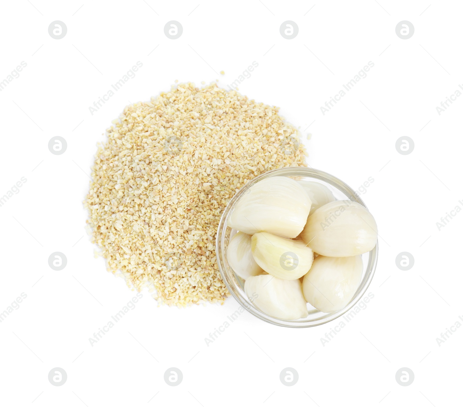 Photo of Heap of dehydrated garlic granules and peeled cloves isolated on white, top view