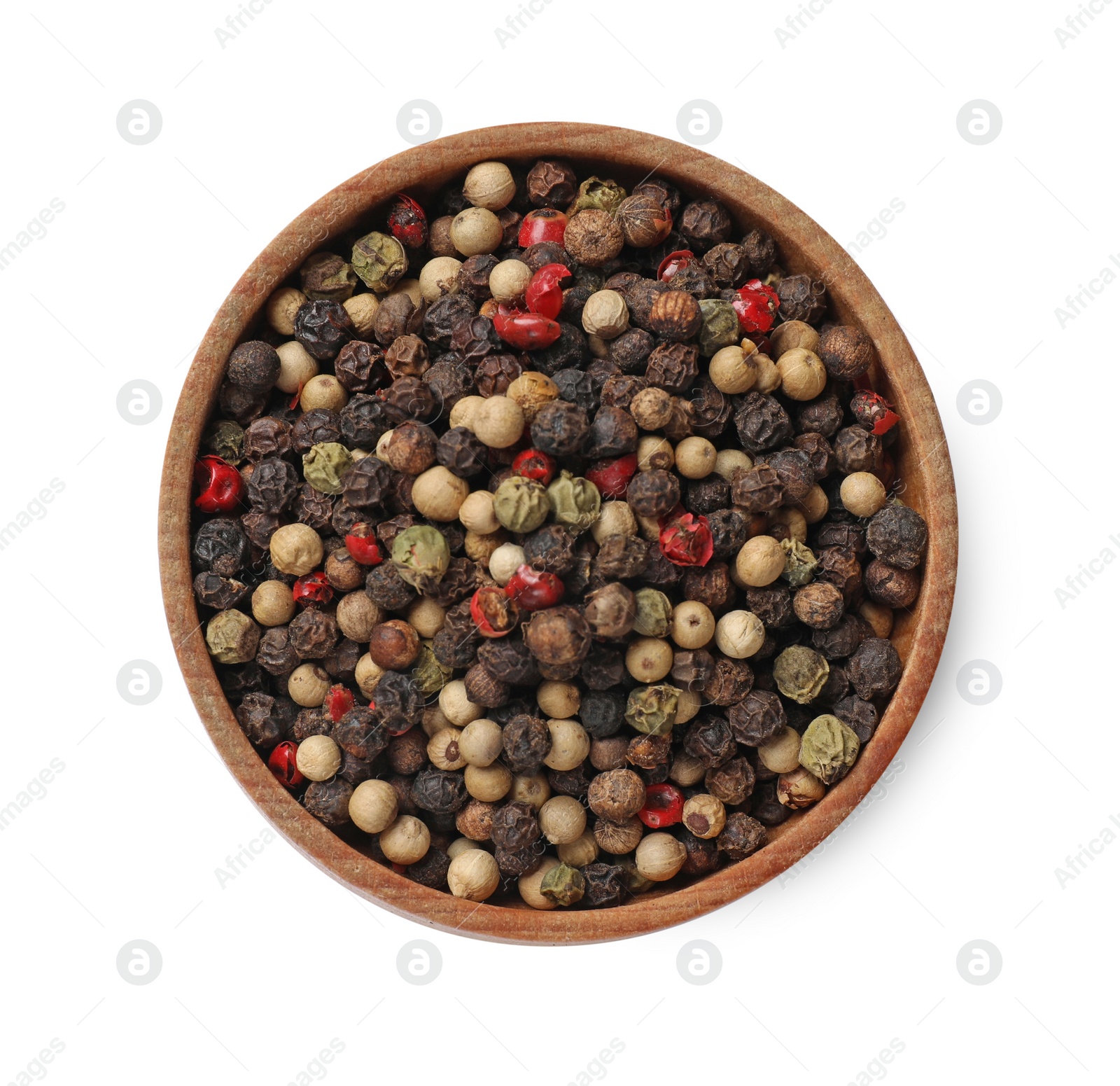 Photo of Aromatic spices. Different peppers in bowl isolated on white, top view