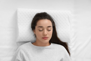 Photo of Woman sleeping on memory foam pillow, top view
