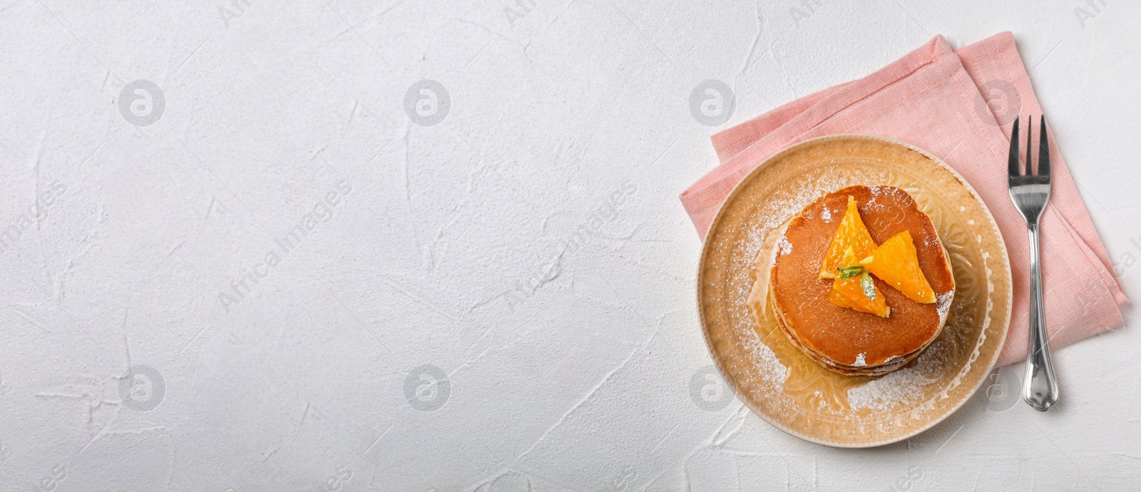 Image of Tasty pancakes served on light table, top view with space for text. Banner design