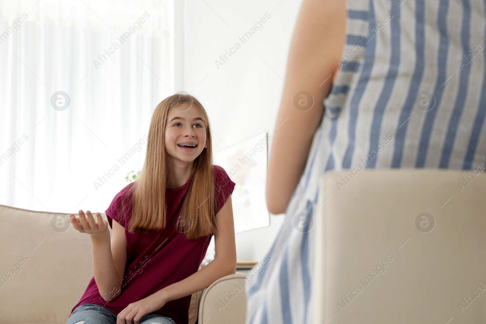 Photo of Mother talking with her teenager daughter at home