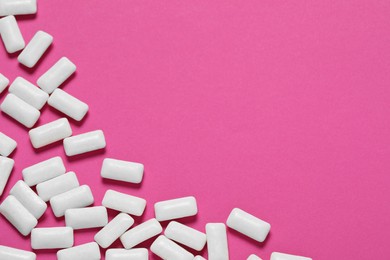 Photo of Tasty white chewing gums on pink background, flat lay