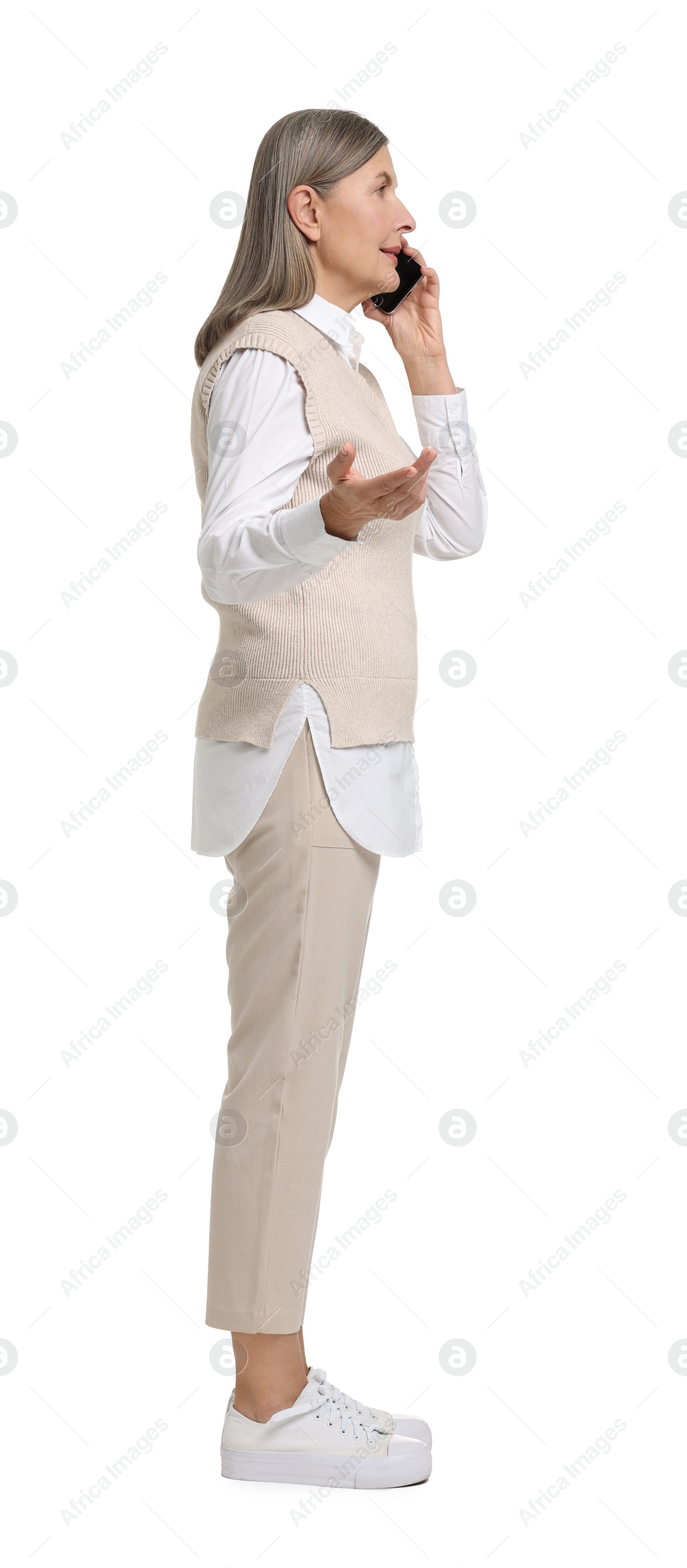 Photo of Senior woman talking on smartphone against white background