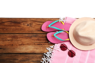 Photo of Beach accessories on wooden table, flat lay. Space for text