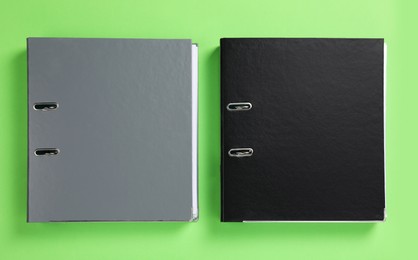 Photo of Office folders on light green background, flat lay