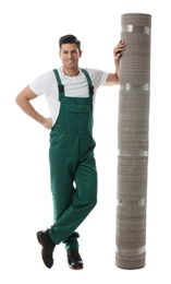 Photo of Male worker with rolled carpet on white background