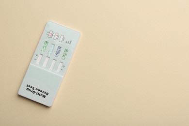 Photo of Multi-drug screen test on beige background, top view. Space for text