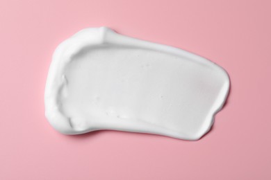 Photo of Sample of shaving foam on pink background, top view